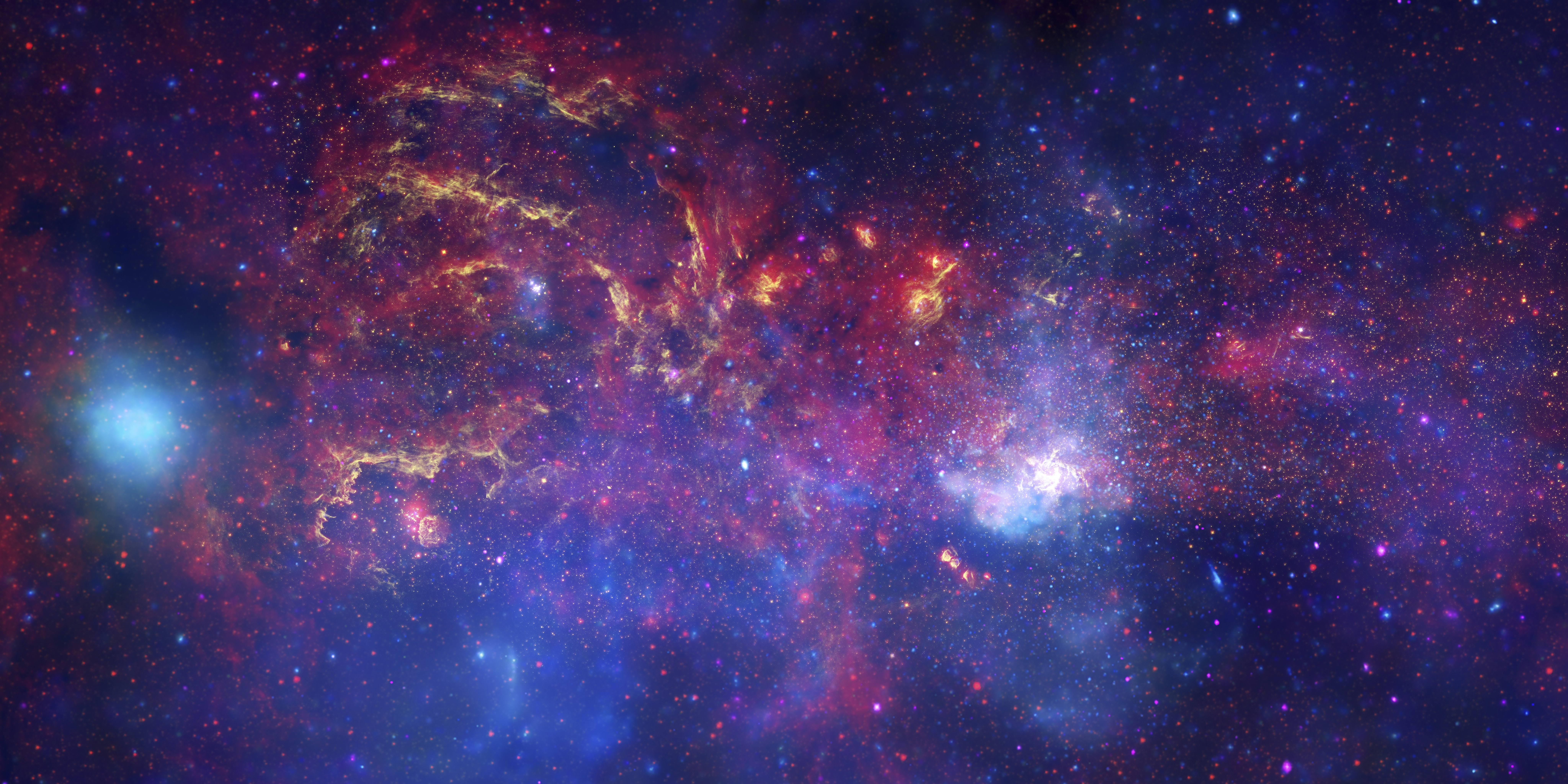 Kuva tiheästä, sipulimaisesta, kaasun ja tähtien täyttämästä avaruuden alueesta.