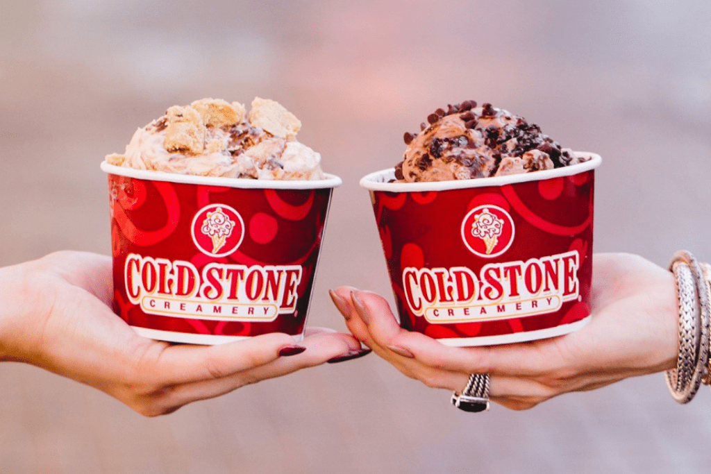 hands holding Cold Stone cream and chocolate ice cream. Fundraising Restaurants In Chicago