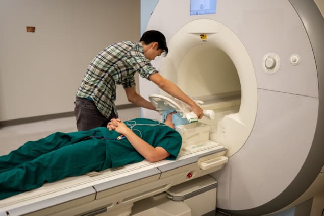 Jerry Tang preparing a study participant for an fMRI scan