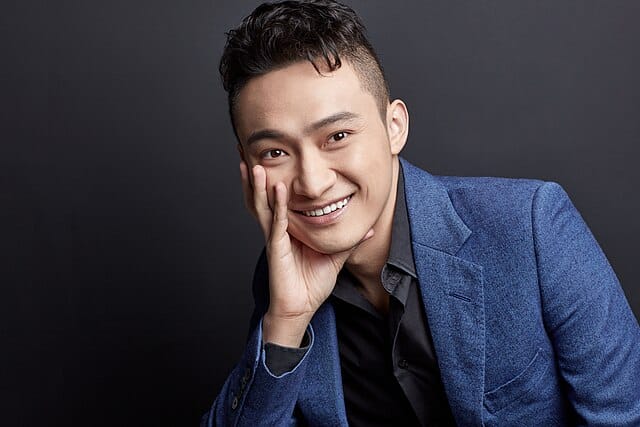 Justin Sun smiling in a blue suit jacket (Wikimedia Commons)