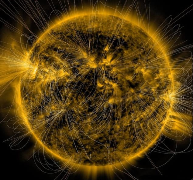 Illustration of the Sun's magnetic fields overlaid on an image captured by NASA’s Solar Dynamics Observatory, showing solar features traced out in bright yellow against a black background